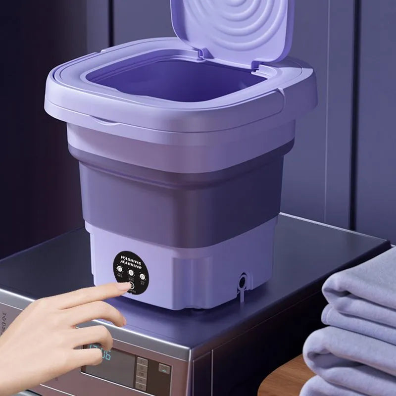 Lavatrice portatile pieghevole viola su lavatrice, design compatto, ideale per piccoli spazi, perfetta per viaggi e camper.