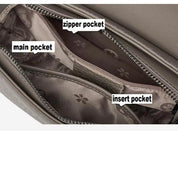 Interno borsa in pelle grigia con tasca principale, tasca con cerniera e tasca interna. Design elegante, ideale per organizzazione e stile.