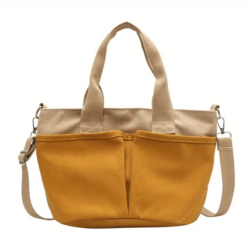 Borsa tote in tela gialla con manici beige, tracolla regolabile e tasche frontali. Design casual, ideale per shopping e uso quotidiano.