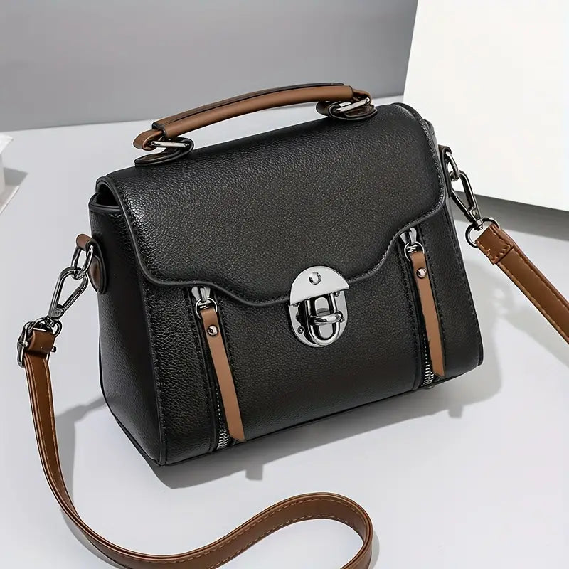 Borsa a tracolla in pelle nera con manico marrone, chiusura a scatto argentata, design elegante e moderno, accessorio moda donna.