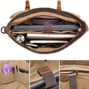 Borsa a tracolla in tela marrone con scomparti interni, laptop, libri, penne e accessori. Design pratico e spazioso per lavoro e viaggio.