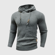 Maglione uomo grigio con cappuccio, design intrecciato, maniche lunghe, stile casual, tessuto morbido, ideale per autunno e inverno.