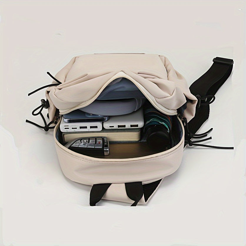 Zaino beige aperto con tasche multiple, contenente dispositivi elettronici e accessori. Design moderno, ideale per viaggi e lavoro.