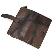 Borsa a mano in pelle marrone scuro, design elegante con chiusura a zip e dettagli a bottoni, accessorio moda uomo e donna, stile vintage.
