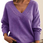 Maglione donna viola con scollo a V, maniche lunghe e dettagli a coste. Elegante e casual, perfetto per l'autunno e l'inverno.