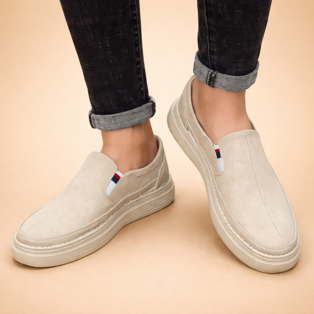 Beige_loafers_on_cuffed_denim_feet.png