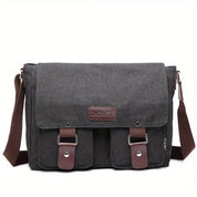 Borsa a tracolla in tela grigia con patta, tasche frontali e dettagli in pelle marrone. Design unisex, ideale per lavoro e tempo libero.
