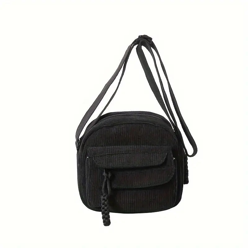 Borsa a tracolla nera in velluto a coste con tasca frontale e chiusura a zip. Design elegante e pratico, ideale per uso quotidiano e moda casual.