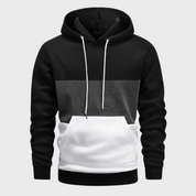 Felpa con cappuccio uomo, design a blocchi di colore nero, grigio e bianco, tasca frontale, cordini bianchi. Moda casual, abbigliamento autunnale.