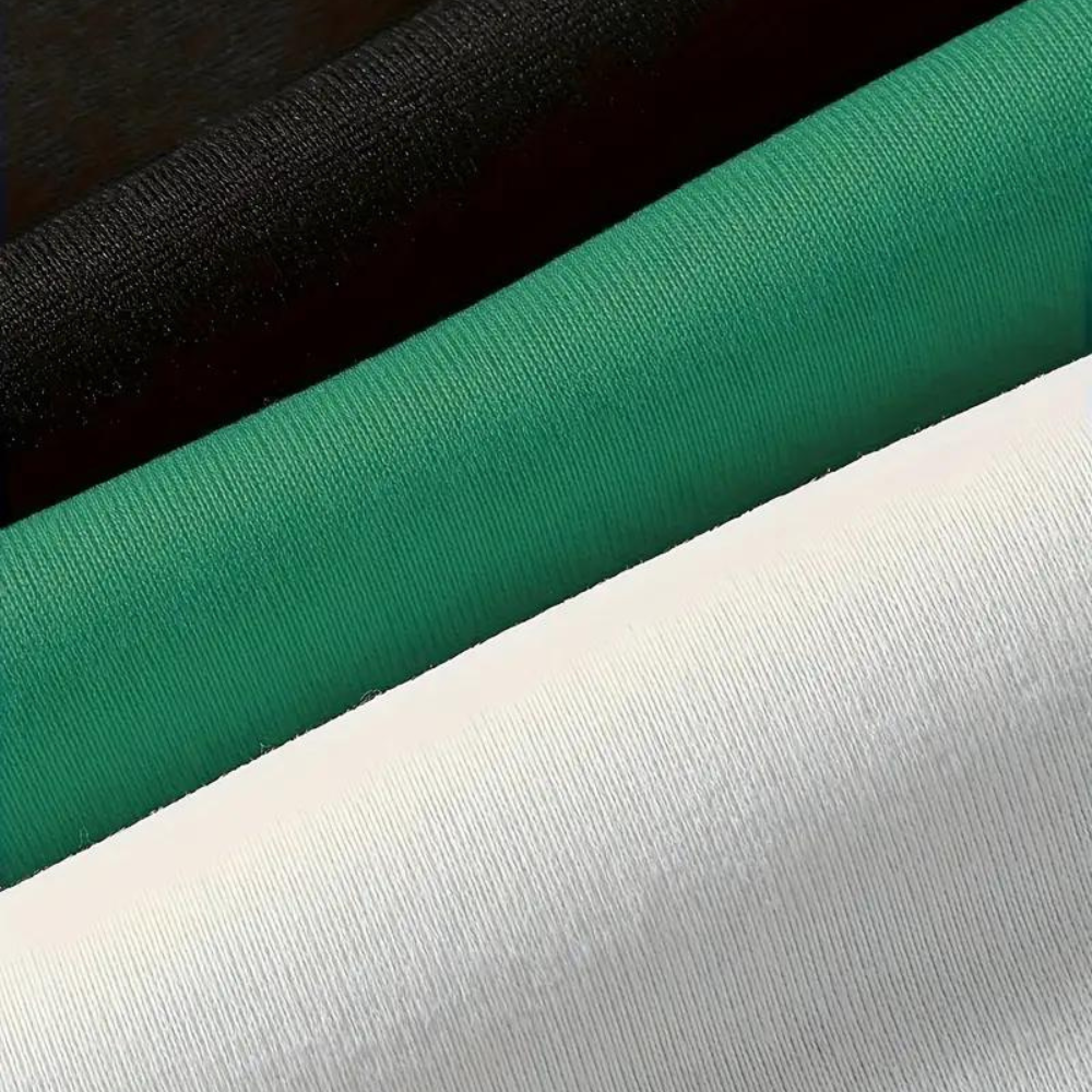 Tre tessuti in cotone: nero, verde e bianco. Materiale morbido e di alta qualità, ideale per abbigliamento e accessori moda.
