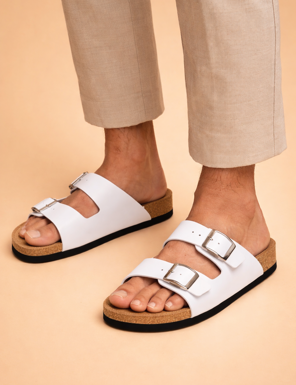 Casual_sandals_on_sandy_backdrop.png