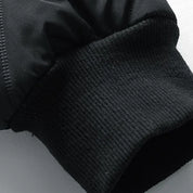 Giacca nera invernale con polsino elasticizzato, tessuto impermeabile, ideale per uomo, moda casual, abbigliamento caldo, resistente al vento.
