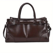 Borsa a mano in pelle marrone scuro, design elegante con doppio manico e tracolla regolabile, ideale per moda donna e accessori di lusso.