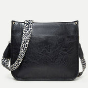 Borsa a tracolla in pelle nera con cinturino leopardato, design elegante e moderno, accessorio moda donna, perfetta per ogni occasione.