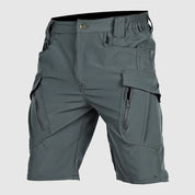 Pantaloncini cargo grigi da uomo, tasche multiple con zip, tessuto resistente, ideale per attività outdoor e casual. Design moderno e funzionale.