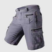 Pantaloncini cargo uomo grigi, tasche multiple con zip, design casual, tessuto resistente, ideale per attività all'aperto e tempo libero.