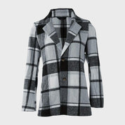 Giacca a quadri bianco e nero, stile casual, tessuto invernale, chiusura a bottoni, design moderno, ideale per moda autunnale e invernale.