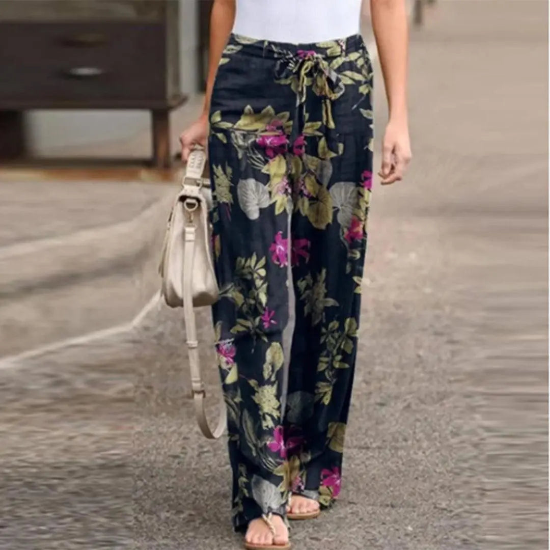 Pantaloni palazzo floreali donna, neri con stampa fiori colorati, vita alta con cintura, stile casual estivo. Perfetti per look eleganti e comodi.