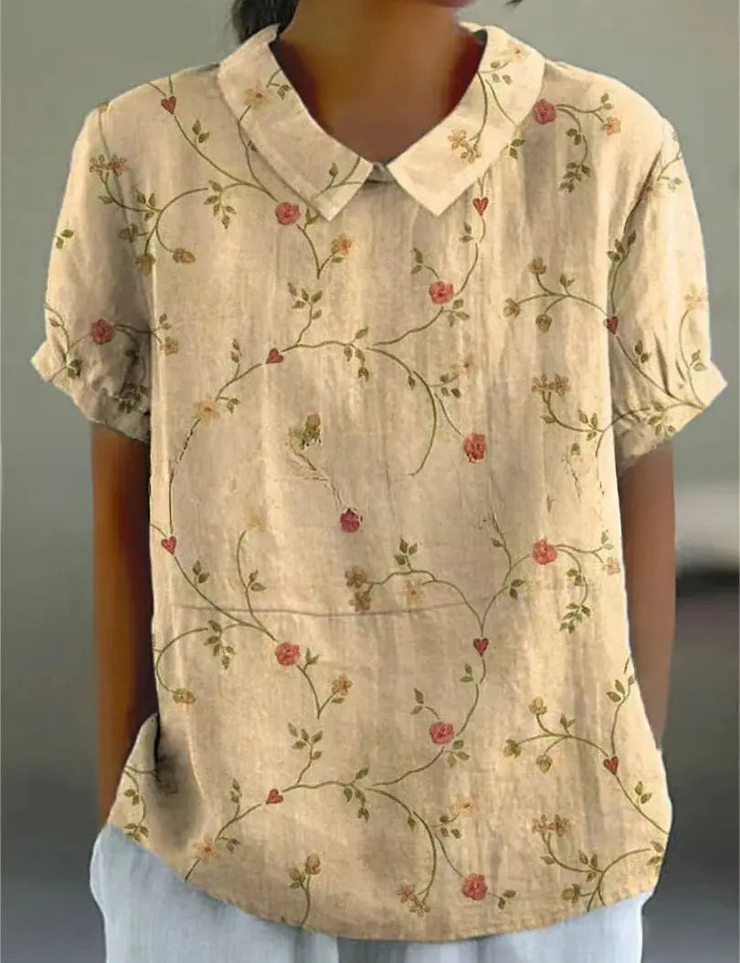 Camicia donna beige con colletto, maniche corte e motivo floreale vintage. Elegante e casual, perfetta per look estivi e primaverili.