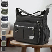 Borsa a tracolla nera in nylon impermeabile con tasche multiple e zip, design unisex, ideale per viaggi e uso quotidiano. Disponibile in vari colori.