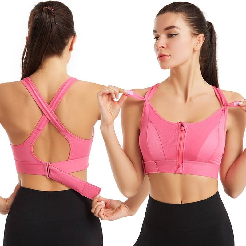 Due donne indossano reggiseni sportivi rosa con chiusura frontale e schiena incrociata, ideali per fitness e yoga. Design comodo e traspirante.