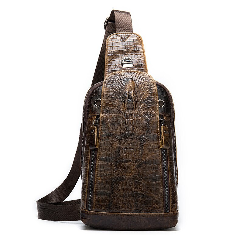 Zaino monospalla in pelle marrone con texture coccodrillo, design elegante, tasche con zip, tracolla regolabile. Accessorio moda uomo/donna.