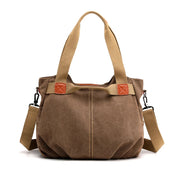 Borsa a tracolla in tela marrone con manici beige, dettagli in pelle marrone chiaro, design casual, ideale per uso quotidiano e shopping.