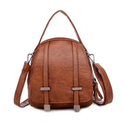 Zaino in pelle marrone elegante con manico superiore e tracolla regolabile, design moderno, ideale per moda donna e accessori di tendenza.