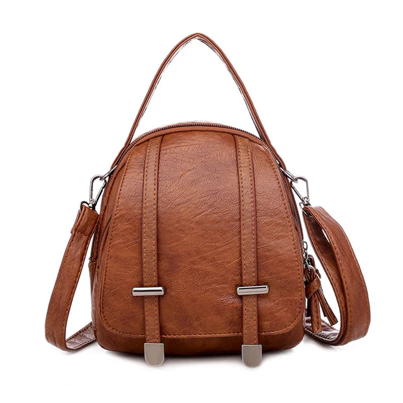 Zaino in pelle marrone elegante con manico superiore e tracolla regolabile, design moderno, ideale per moda donna e accessori di tendenza.