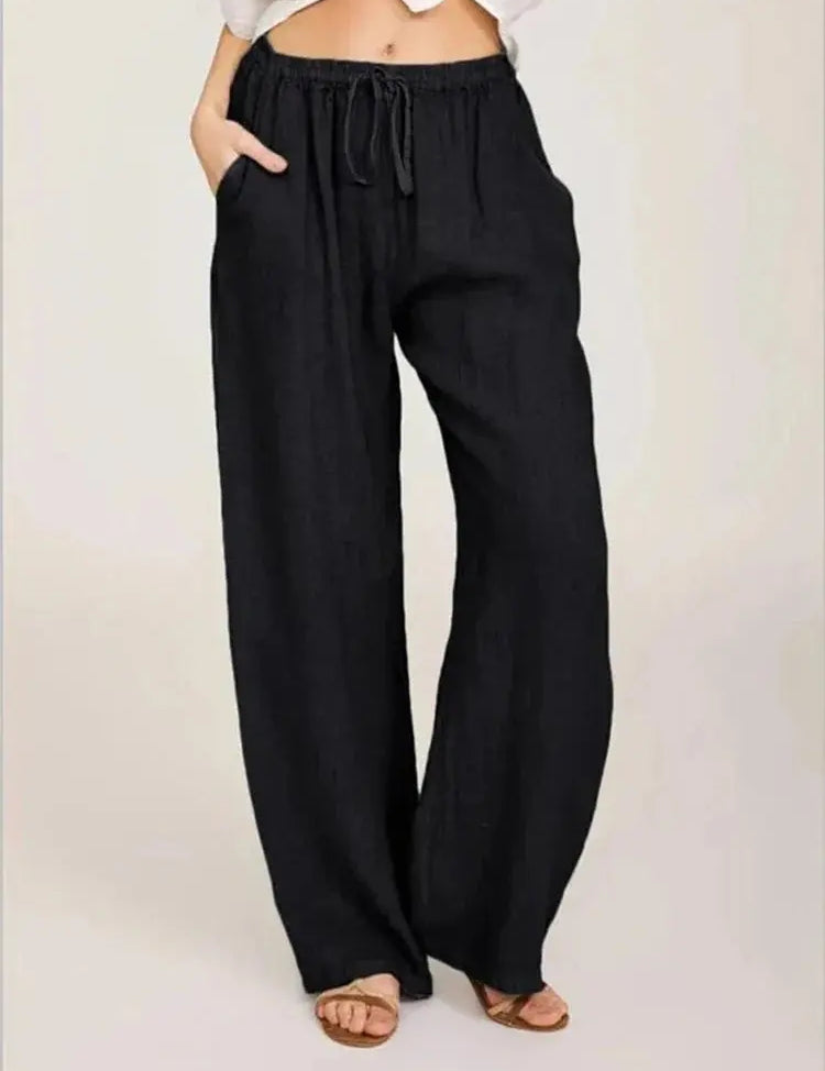 Pantaloni larghi neri da donna, vita alta con laccio, tessuto leggero, stile casual, perfetti per l'estate.