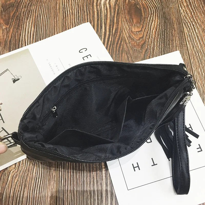 Borsa a tracolla nera in pelle sintetica con cerniera aperta, vista interna. Design elegante, ideale per moda donna e accessori casual.