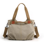 Borsa a tracolla in tela beige con manici marroni, design casual e spazioso, ideale per uso quotidiano. Accessorio moda donna versatile e resistente.
