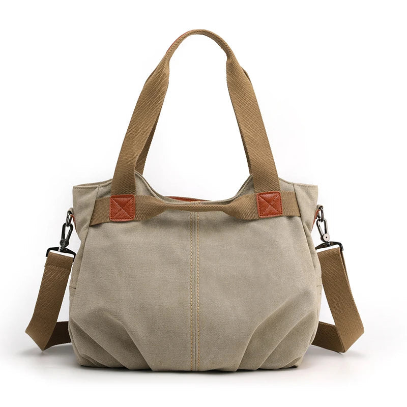 Borsa a tracolla in tela beige con manici marroni, design casual e spazioso, ideale per uso quotidiano. Accessorio moda donna versatile e resistente.