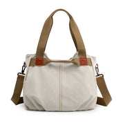 Borsa a tracolla in tela beige con manici marroni, design casual e spazioso, ideale per uso quotidiano. Accessorio moda donna versatile e resistente.