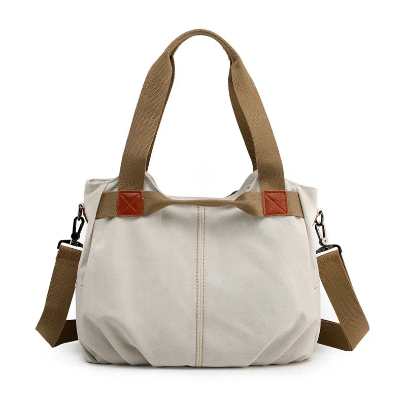 Borsa a tracolla in tela beige con manici marroni, design casual e spazioso, ideale per uso quotidiano. Accessorio moda donna versatile e resistente.