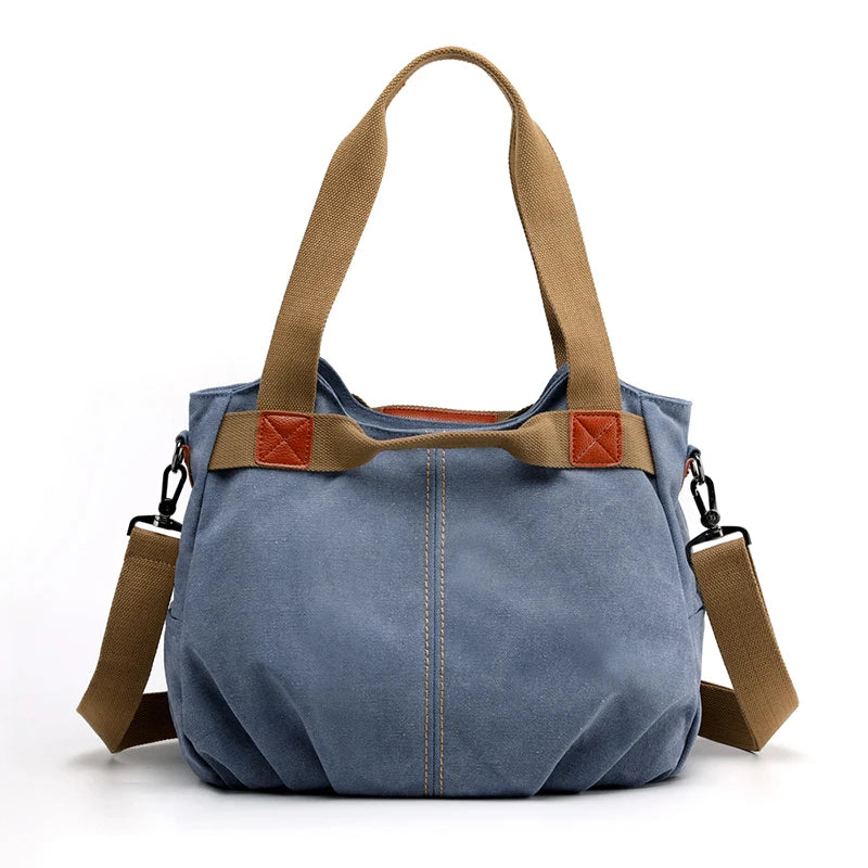 Borsa a tracolla in tela blu con manici marroni, design casual, chiusura a zip, ideale per donna, moda quotidiana, resistente e spaziosa.