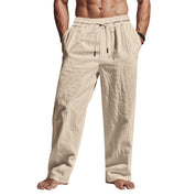 Pantaloni uomo beige in lino, elastico in vita con coulisse, tasche laterali, stile casual estivo.