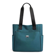 Borsa tote donna in pelle blu con manici neri, tasche laterali e chiusura con zip. Elegante e spaziosa, ideale per l'uso quotidiano.