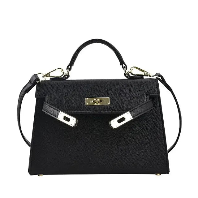 Borsa a mano nera in pelle con tracolla removibile, chiusura a girello dorata, design elegante e classico. Accessorio moda donna di lusso.