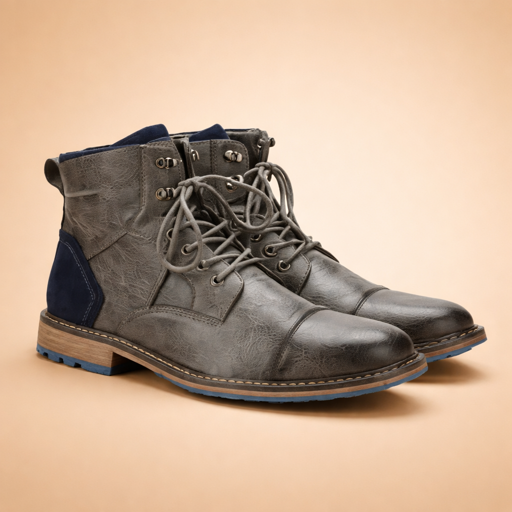 Rugged_grey_leather_boots_on_sand.png