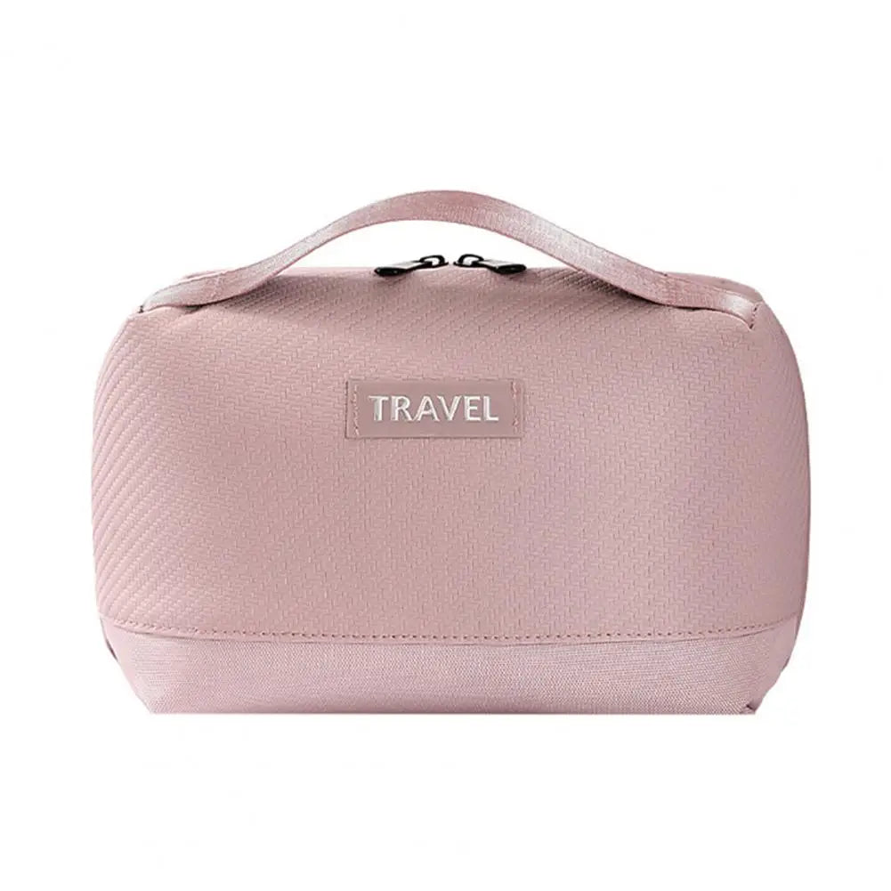 Borsa da viaggio rosa con manico, design compatto e chiusura a zip. Ideale per organizzare accessori e cosmetici. Perfetta per viaggi.