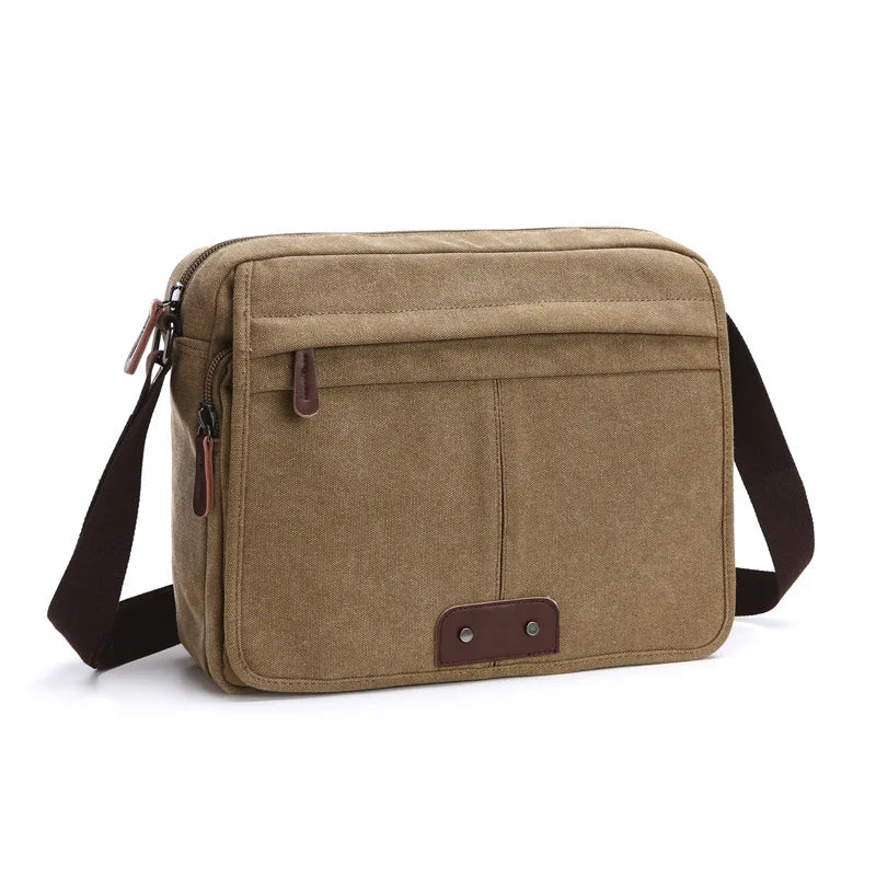 Borsa a tracolla in tela marrone, design casual, tasca frontale con cerniera, dettagli in pelle, ideale per uomo e donna, perfetta per uso quotidiano.