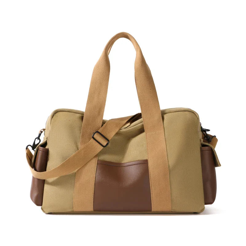 Borsa a tracolla in tela beige e marrone, design elegante e funzionale, con manici robusti e tasche laterali, ideale per viaggi e uso quotidiano.
