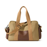 Borsa a tracolla in tela beige e marrone, design elegante e funzionale, con manici robusti e tasche laterali, ideale per viaggi e uso quotidiano.