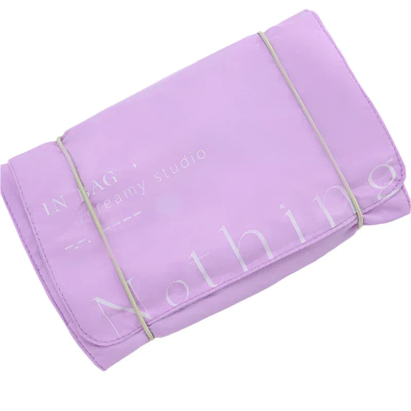 Borsa organizer da viaggio viola, pieghevole, con elastico. Ideale per cosmetici e accessori. Design compatto e pratico per valigia.