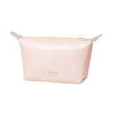 Astuccio cosmetico beige in silicone, design minimalista, chiusura con zip, ideale per organizzare trucchi e accessori da viaggio.