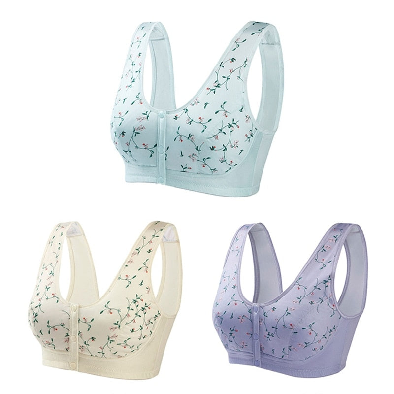 Tre reggiseni sportivi senza cuciture in colori pastello: azzurro, crema e lilla, con stampa floreale. Comfort e supporto per attività quotidiane.