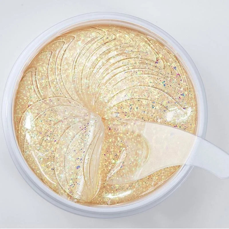 Maschera viso in gel dorato con glitter, idratante e illuminante, vista dall'alto. Trattamento skincare per pelle luminosa e radiosa.