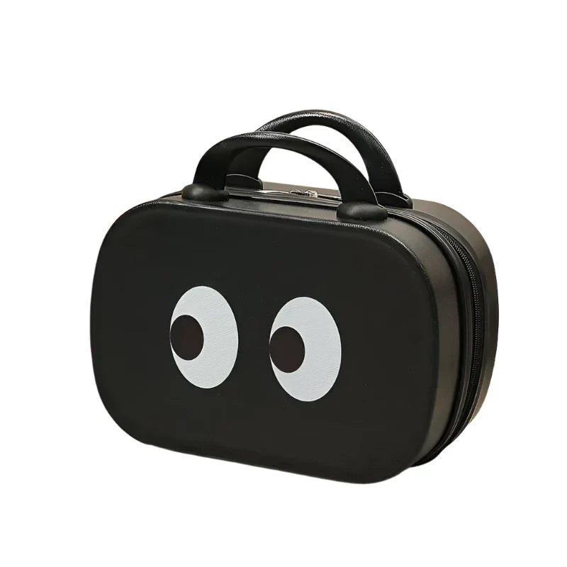 Valigia nera con occhi stilizzati, design moderno, manico superiore, ideale per viaggi brevi. Accessorio moda, bagaglio a mano compatto.