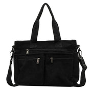 Borsa a tracolla nera in tessuto con manici, tasche frontali con cerniera e tracolla regolabile. Design elegante e funzionale per uso quotidiano.